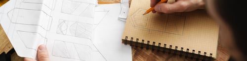 Preview: White craftsman drawing while working with leather in workshop