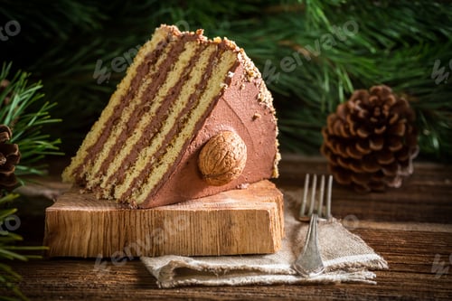 Preview: Piece of walnut cake on wood on old wooden table