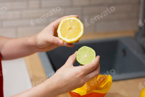 Preview: Womans hands holding half of orange and lime