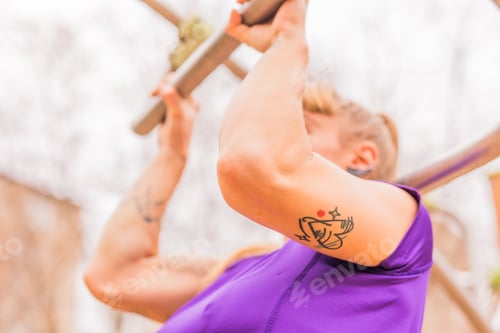Preview: Calisthenics pull- up back exercise for cross fitness workout. Hispanic mid sportswoman athletic