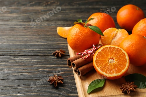 Preview: Board with mandarins and cinnamon on wooden background