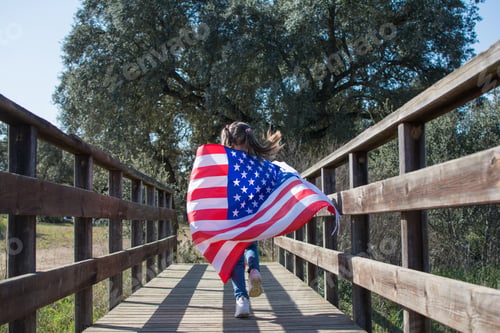 Preview: Girl running on wooden bridge with usa flag