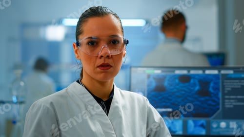 Preview: Tired chemist doctor looking at camera sighing