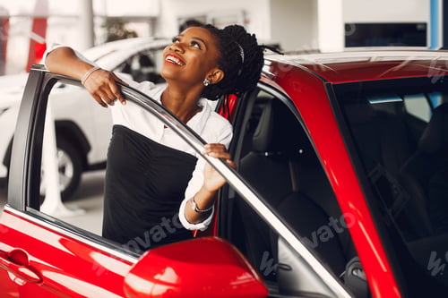 Preview: Stylish black woman in a car salon