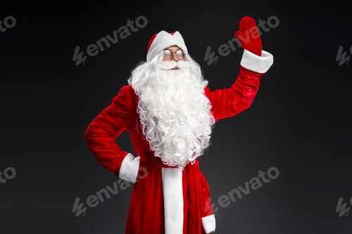 Preview: Santa Claus waving hand looking away isolated on black background