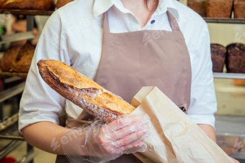 Preview: Cheerful baker delivering bread to client in store