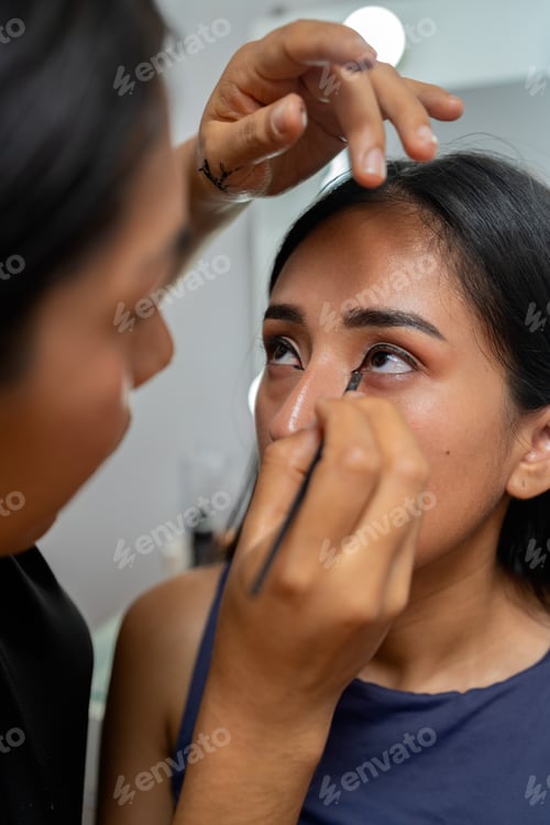 Preview: Young latina woman receiving professional eye makeup application