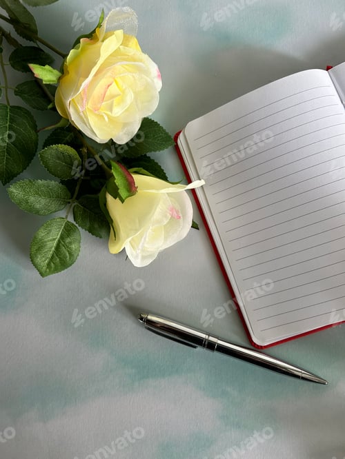 Preview: Open book with pen and yellow roses