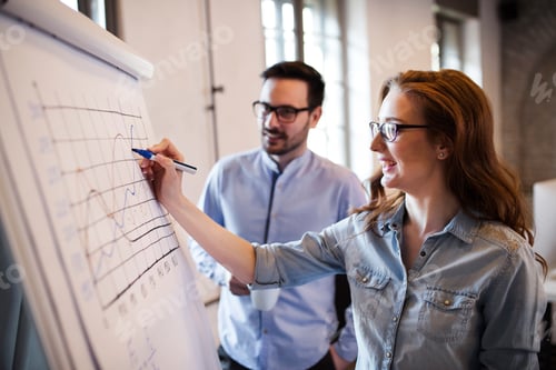 Preview: Portrait of architects discussing and drawing on board