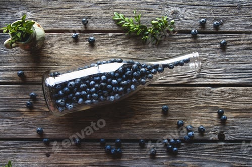 Preview: Blueberries in a bottle on wooden background