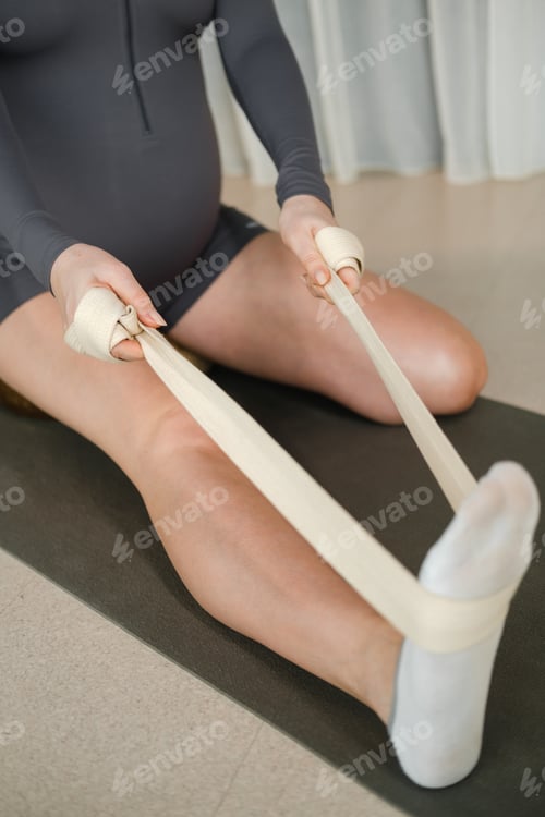 Preview: Two women practice stretching exercises in a bright studio during a workout session focused