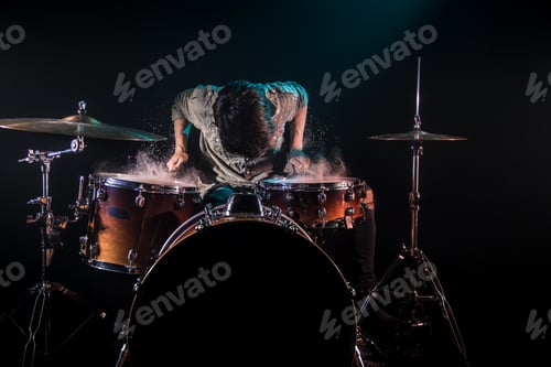 Preview: musician playing drums with splashes, black background with beautiful soft light