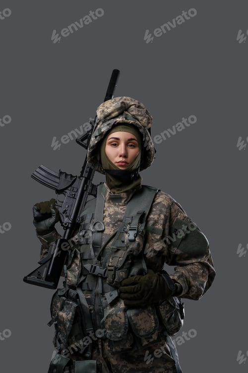 Preview: Female soldier looking at camera against gray background
