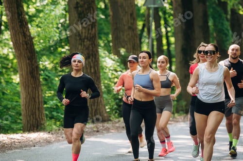 Preview: Front view. Group of runners are together outdoors