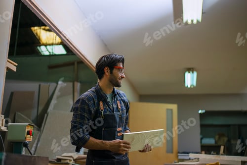 Preview: Carpenter is working at workshop.