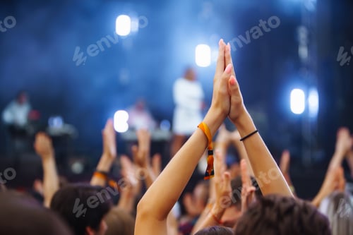 Preview: Hand with a phone records live music festival. People taking photographs with smart phone.