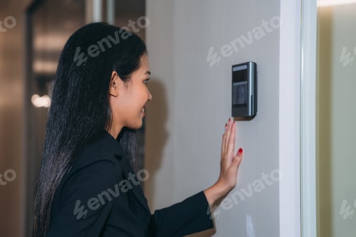 Preview: A face scanner being used by a woman to open a door at an office building.
