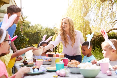 Preview: Parents With Children Wearing Bunny Ears Enjoying Outdoor Easter Party In Garden At Home