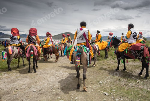 Preview: Tibet - August, 29 2014: Anonymous men riding horses on cloudy day