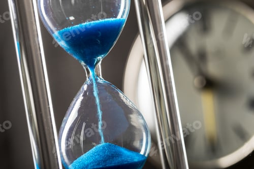 Preview: Time is passing. Blue hourglass close up