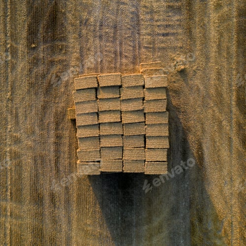 Preview: Top shot of nicely stacked rectangle straw hay bales in the field