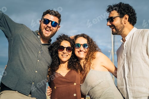 Preview: Group of adult friends laughing together on a yacht at the marina