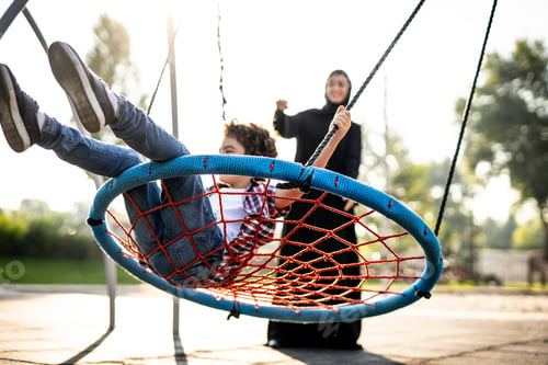 Preview: Woman with her children at the playground