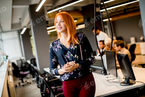 Preview: Pretty young businesswoman holding a digital tablet