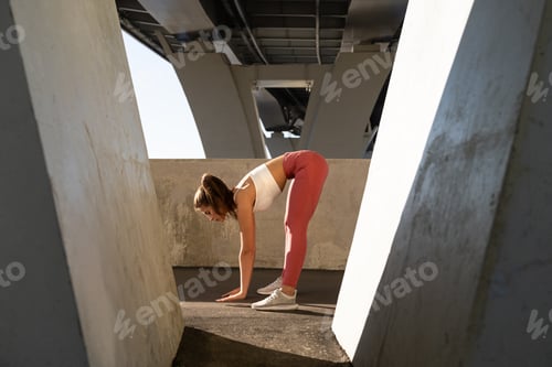 Preview: Female stretching muscles making functional training makes slope before workout and jogging outdoors