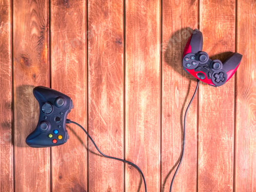 Preview: two video game devices on the wooden table with copy space