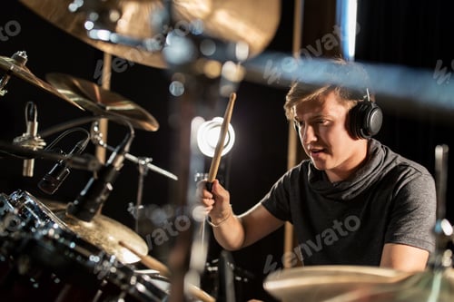 Preview: male musician playing drums and cymbals at concert