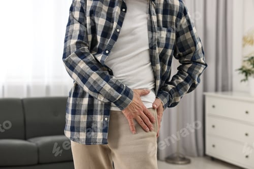Preview: Arthritis symptoms. Man suffering from hip joint pain at home, closeup