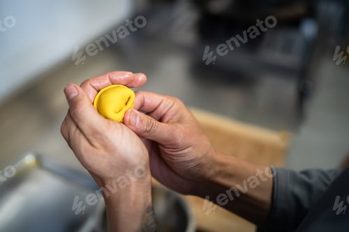 Preview: Chef shaping a dumpling with hands in a professional kitchen