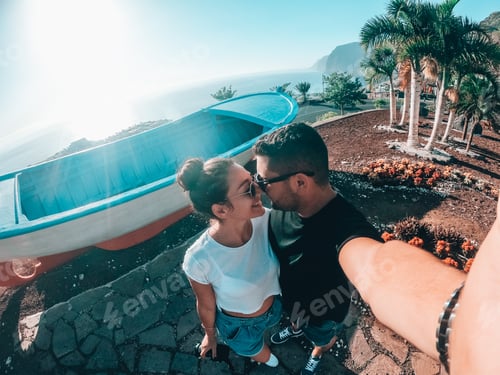 Preview: Affectionate Couple Posing by an Upside Down Boat