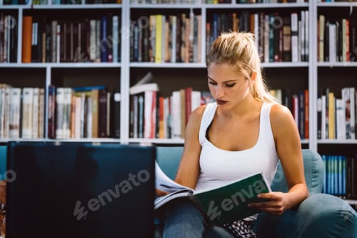 Preview: Education, study and home concept. Happy smiling student girl studying, learning for exam