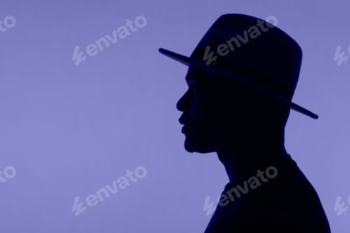Preview: Man silhouette pose with hat on very peri colour of 2022 background with copy space