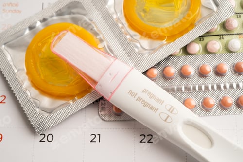 Preview: Pregnancy test and birth control pills on calendar, contraception health and medicine.