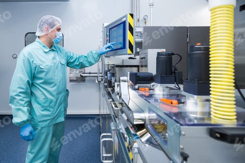 Preview: Pharmacy industry factory man worker in protective clothing in sterile working conditions operating