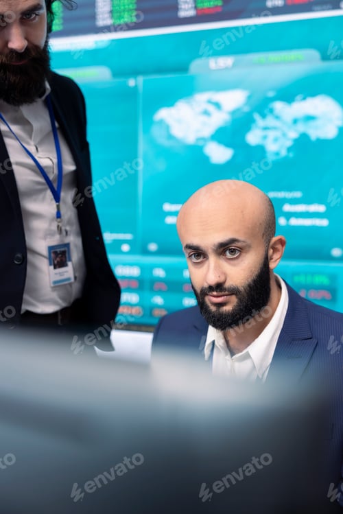 Preview: Financial analyst works on resource allocation plans with his staff