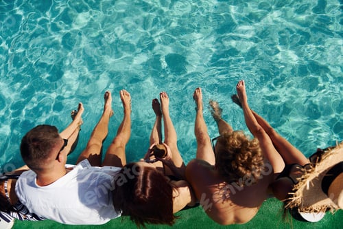Preview: Top view of group of young happy people that have fun in swimming pool at daytime