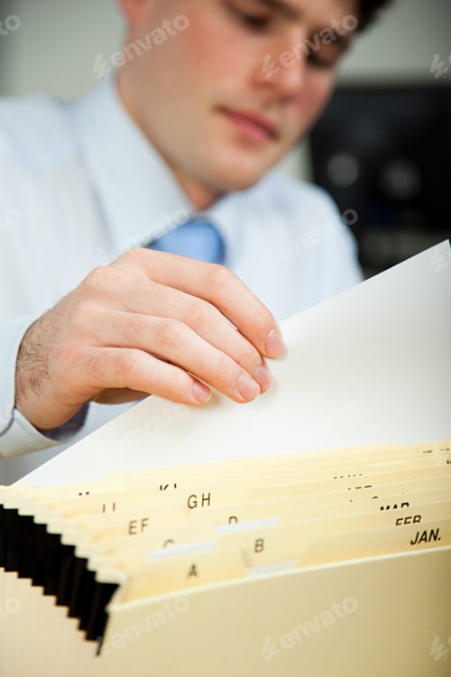 Preview: Office worker filing document