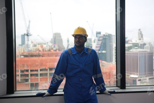 Preview: Construction, young worker working under factory construction.
