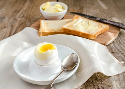 Preview: Boiled egg with crispy toasts on the wooden table