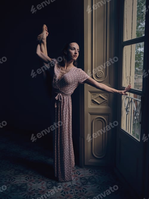 Preview: Graceful ballerina performing standing split in dark room