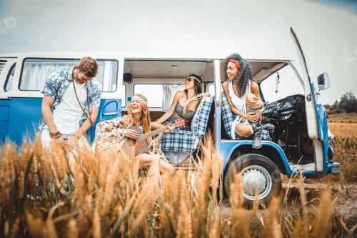 Preview: Happy friends driving a vintage minivan