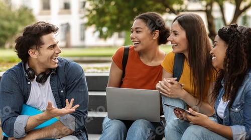 Preview: College Crush. Handsome Guy Talking To Group Of Happy Female Students Outdoors