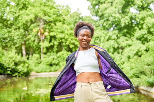 Preview: Portraits of a young African woman in a park, standing with a serene lake in the background