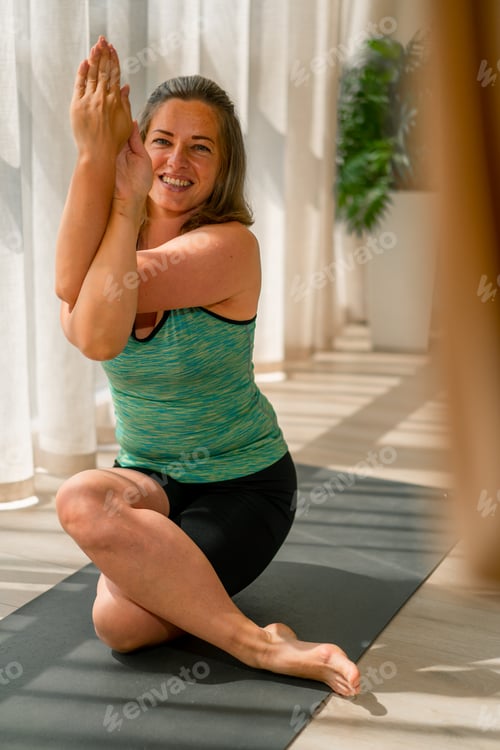 Preview: plump smiling girl in a sports uniform performs yoga exercises hobby active lifestyle