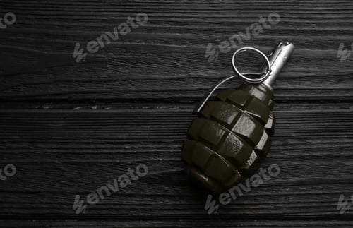 Preview: Hand grenade on black wooden table, top view. Space for text