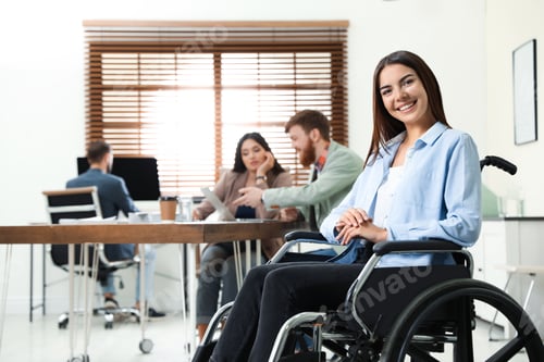 Preview: Young woman in wheelchair with colleagues at office